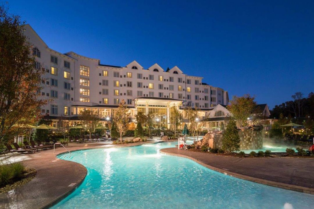 Resort pool built by Reliable, illuminated at dusk